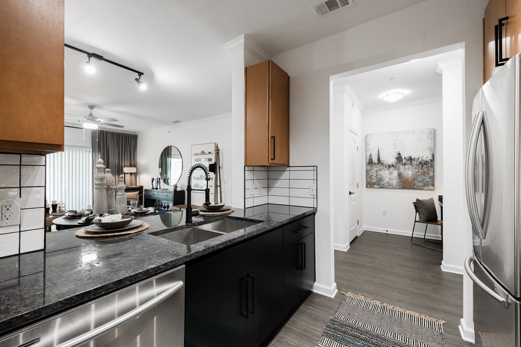 a kitchen with black granite countertops and stainless steel appliances