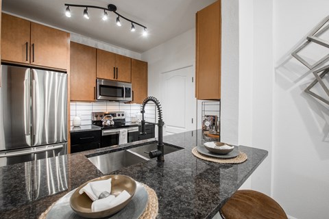 a kitchen with stainless steel appliances and granite counter tops