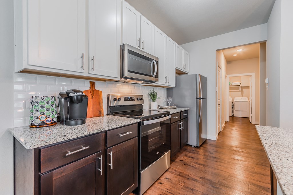 a kitchen with stainless steel appliances and granite counter tops
