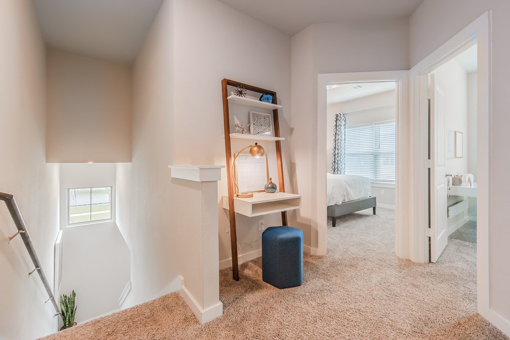 a home office with a desk and a mirror in a bedroom