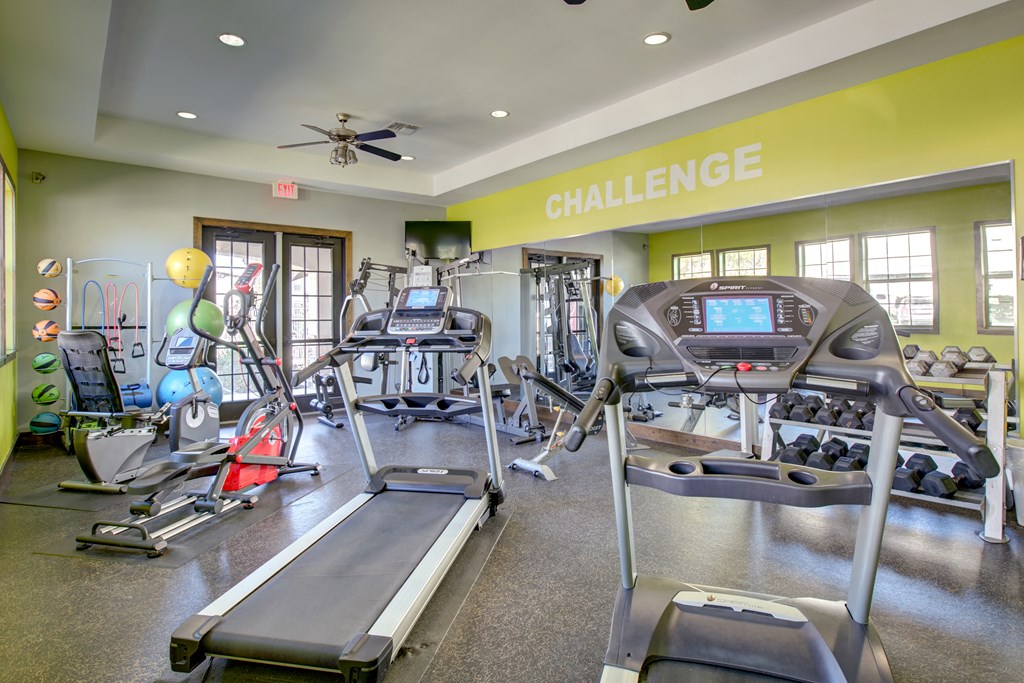 a gym with treadmills and other exercise equipment