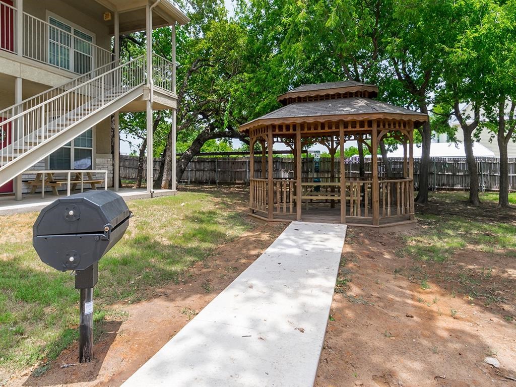 a gazebo in the yard of a house with a parking meter