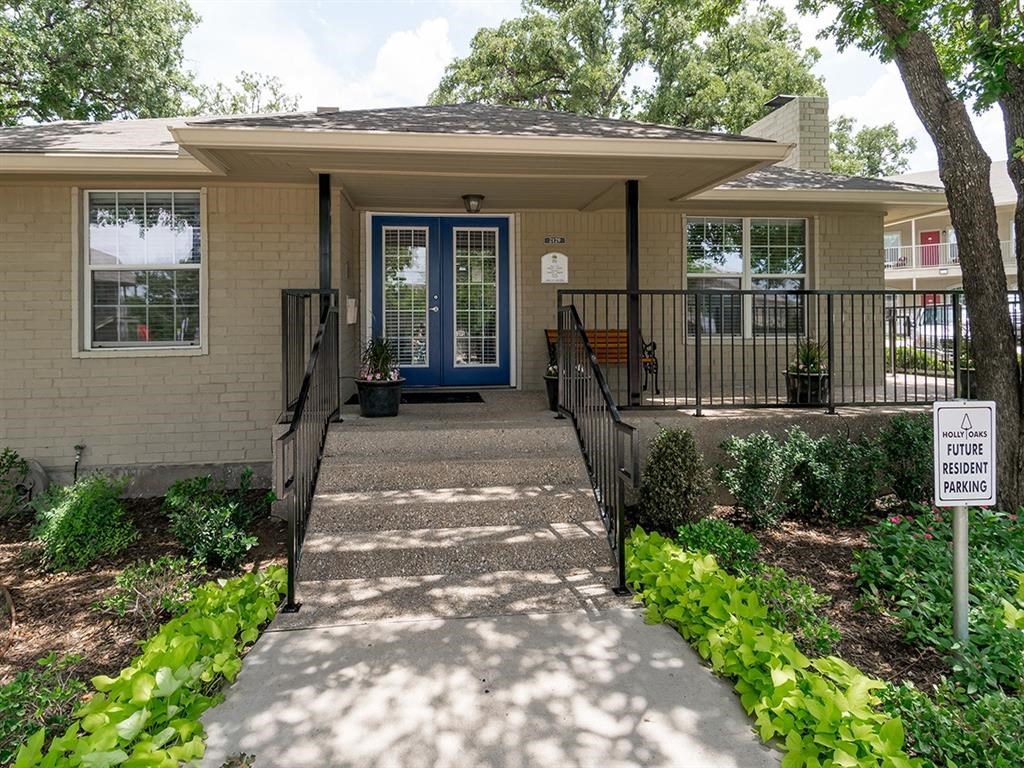 a house with a blue door and a sidewalk in front of it