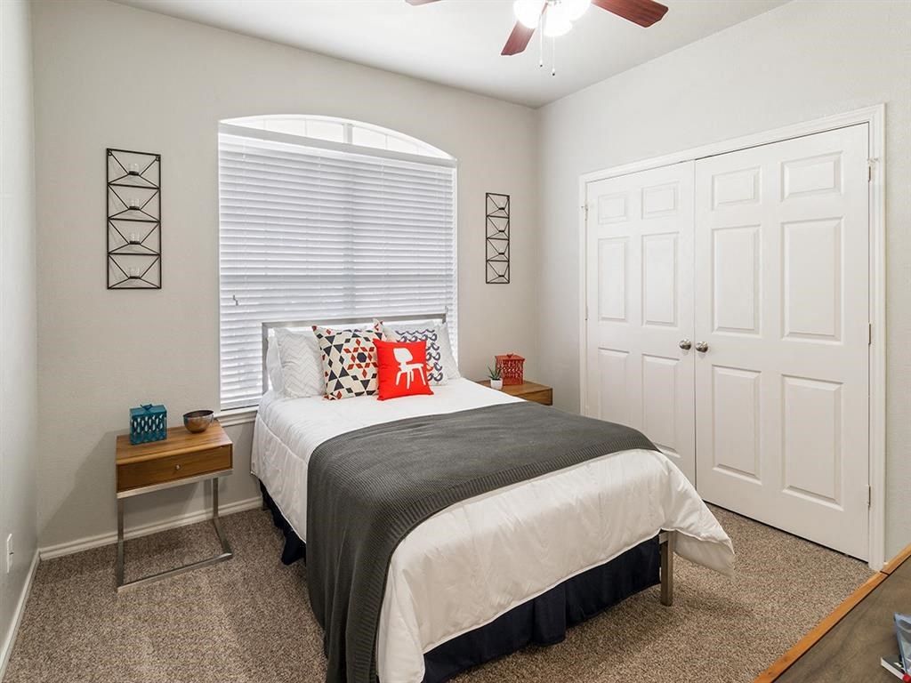 a bedroom with a bed and a window