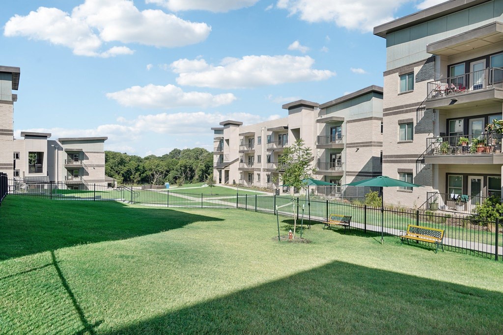 a large green lawn in front of an apartment building