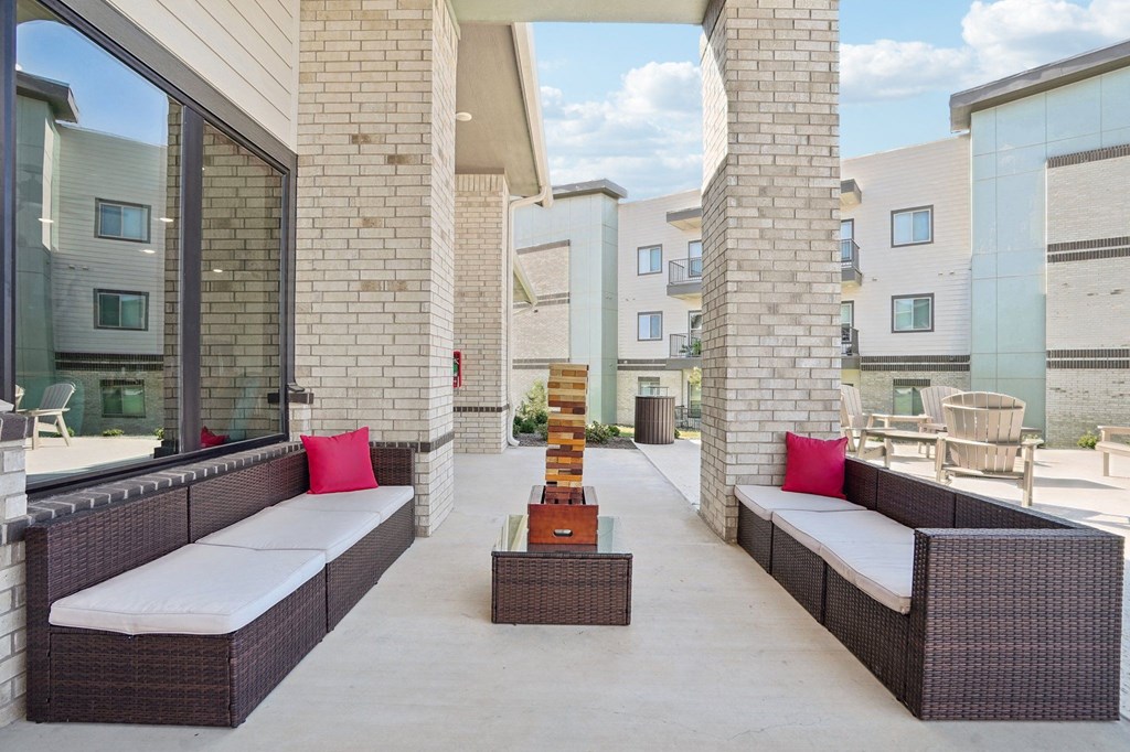 a patio with couches and a coffee table