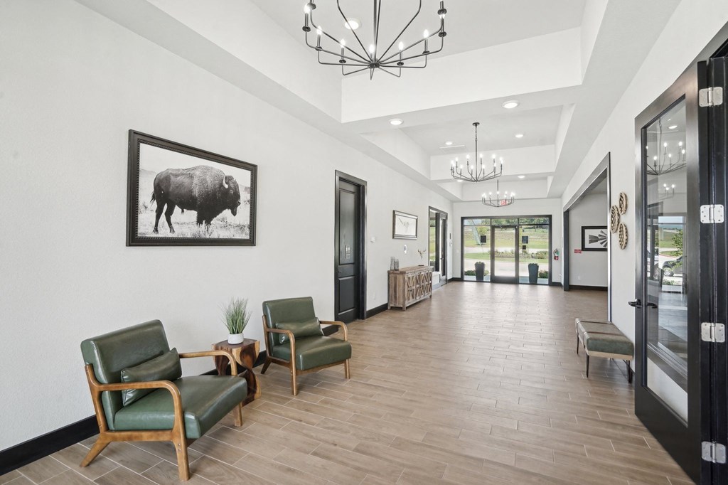 a long hallway with chairs and a large picture of a bull
