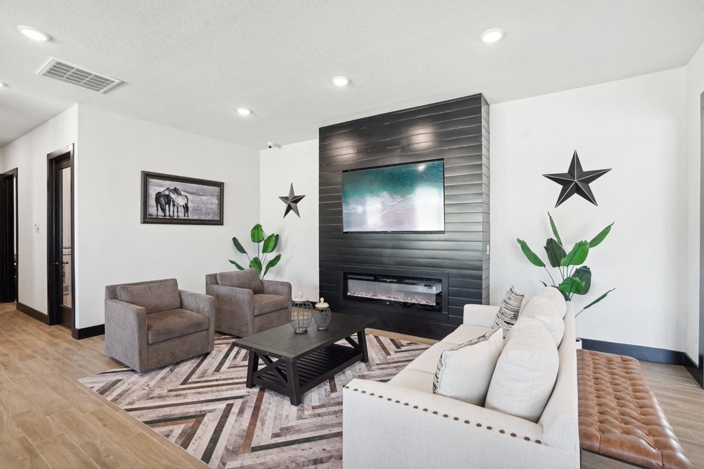 a living room with a couch and chairs and a fireplace
