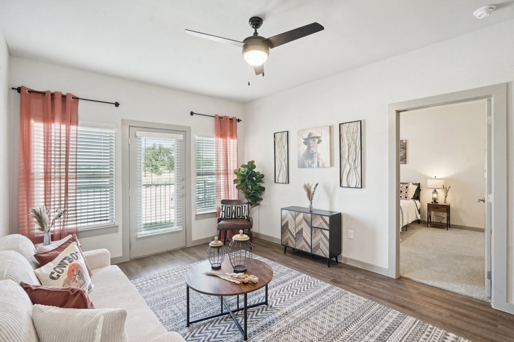 a living room with a couch and a ceiling fan