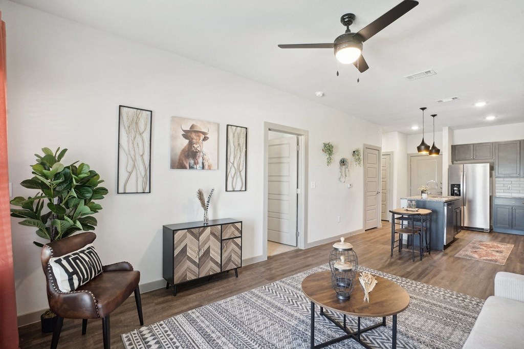 a living room with a ceiling fan and a dining room table