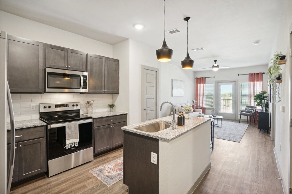 a kitchen with stainless steel appliances and a counter top