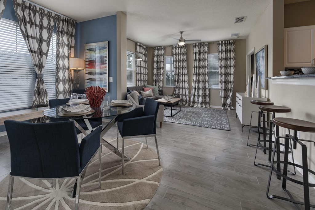 an open floor plan with a dining table and chairs