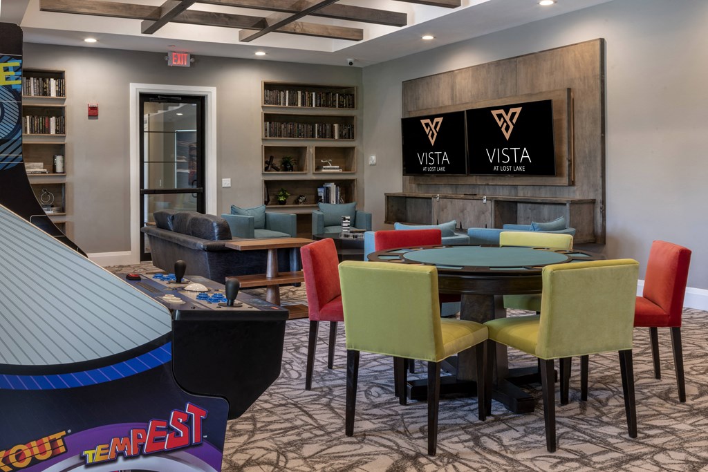 a room with a table and chairs in front of a tv