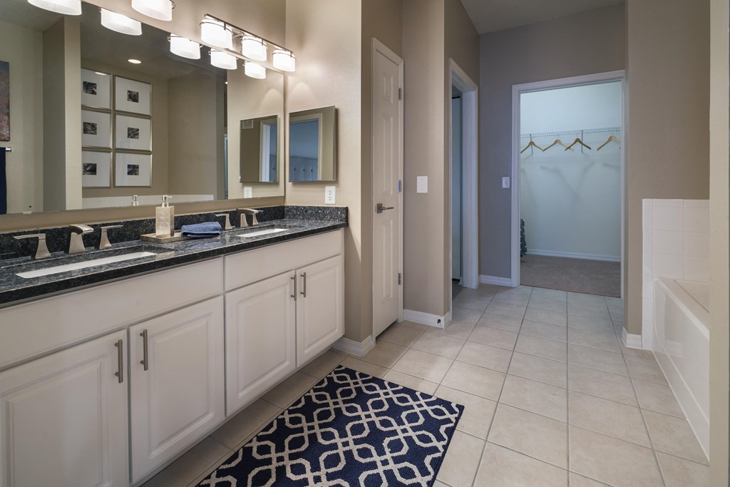 a bathroom with a large mirror and double sinks