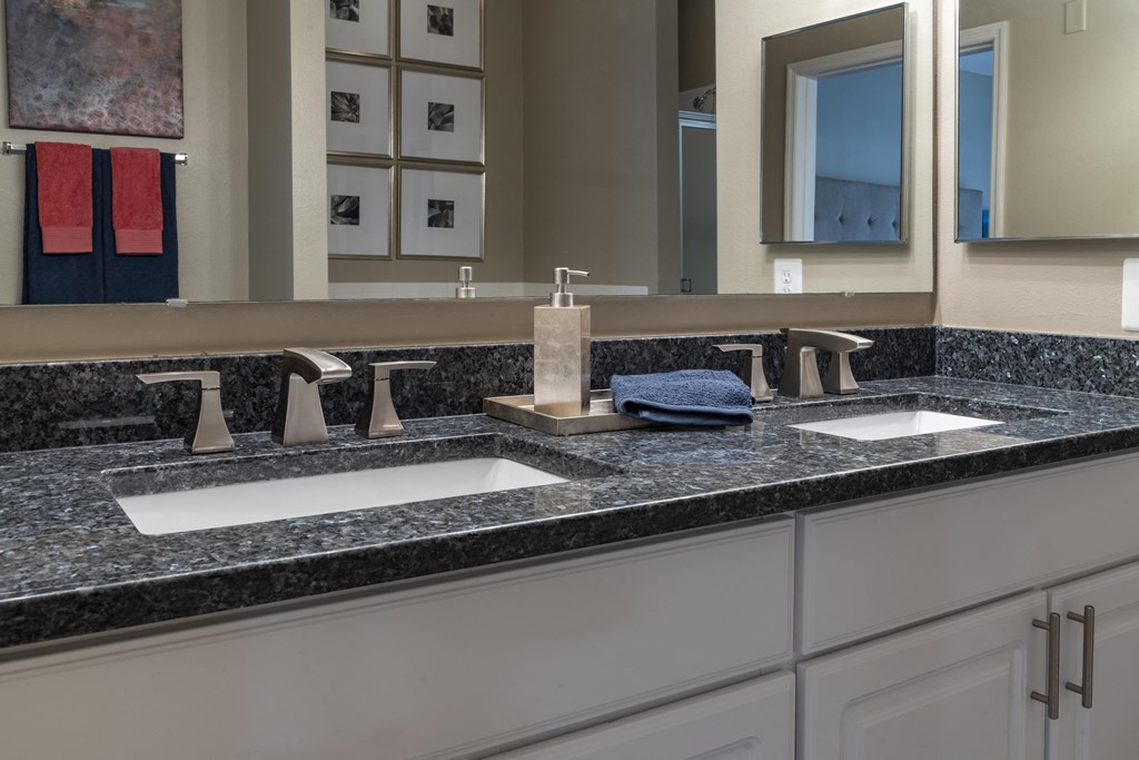 a bathroom with two sinks and a large mirror