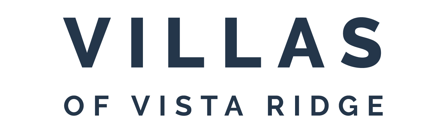 A green sign with the words "VILLAS OF VISTA RIDGE" written in white.