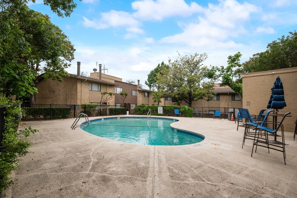 our apartments have a resort style pool with chairs and umbrellas