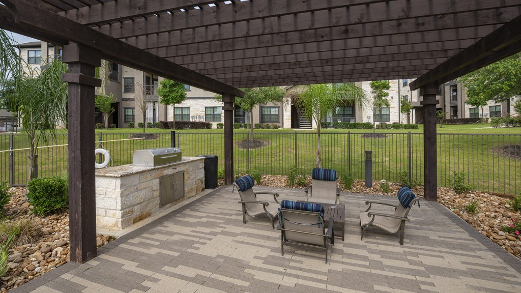 a covered patio with a table and chairs