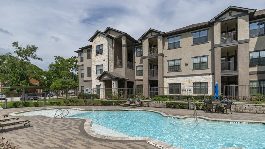 the preserve at ballantyne commons swimming pool with apartment buildings in the background