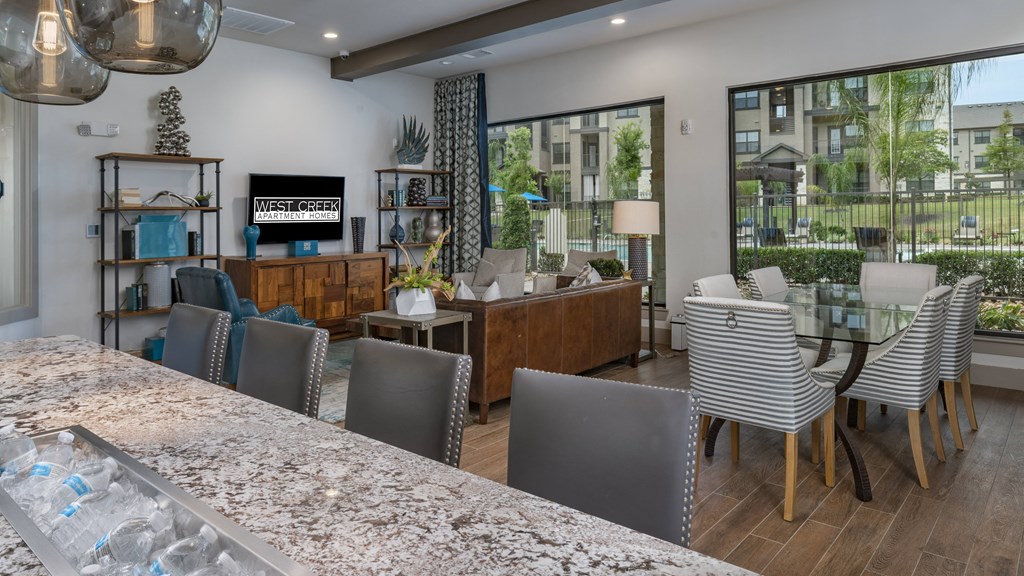 a kitchen and dining area with a table and chairs and a large window