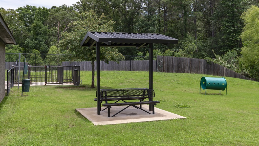 a picnic table and awning in a park
