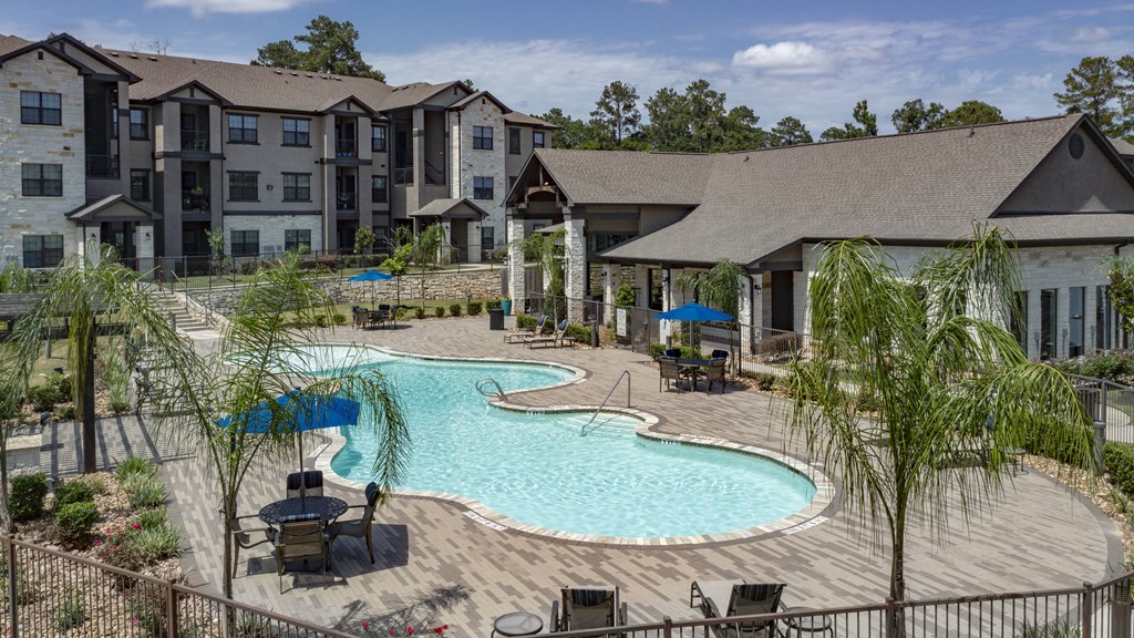 our apartments have a large swimming pool with chairs and umbrellas