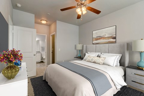 a bedroom with a large bed and a ceiling fan