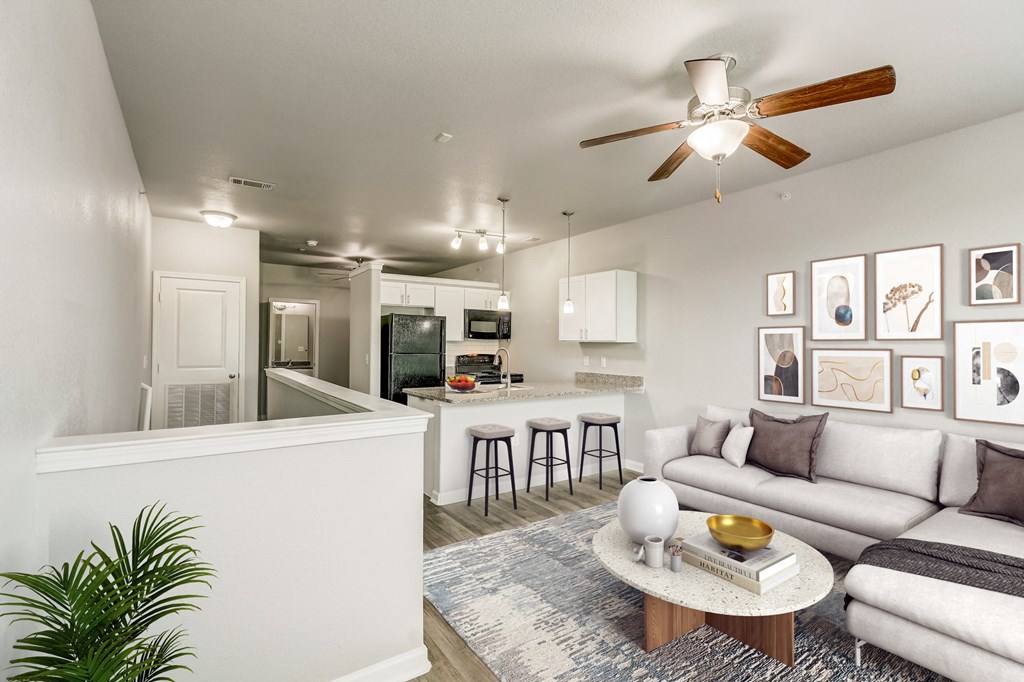a living room and kitchen with a ceiling fan