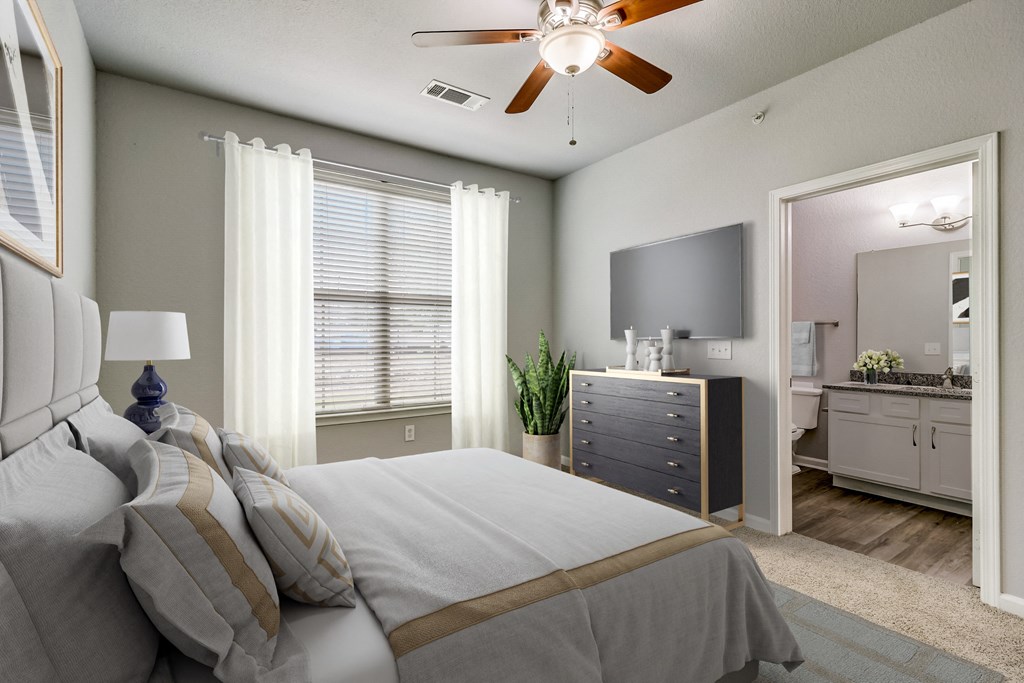 a bedroom with a large bed and a ceiling fan