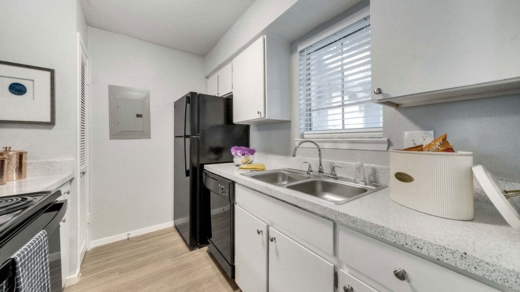 a kitchen with a sink and a refrigerator
