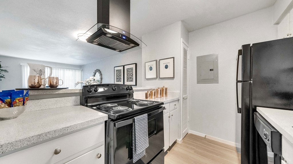 a kitchen with a stove and a refrigerator