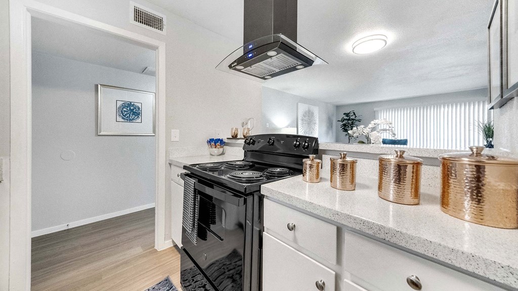 the kitchen has stainless steel appliances and a counter top with pots and pans