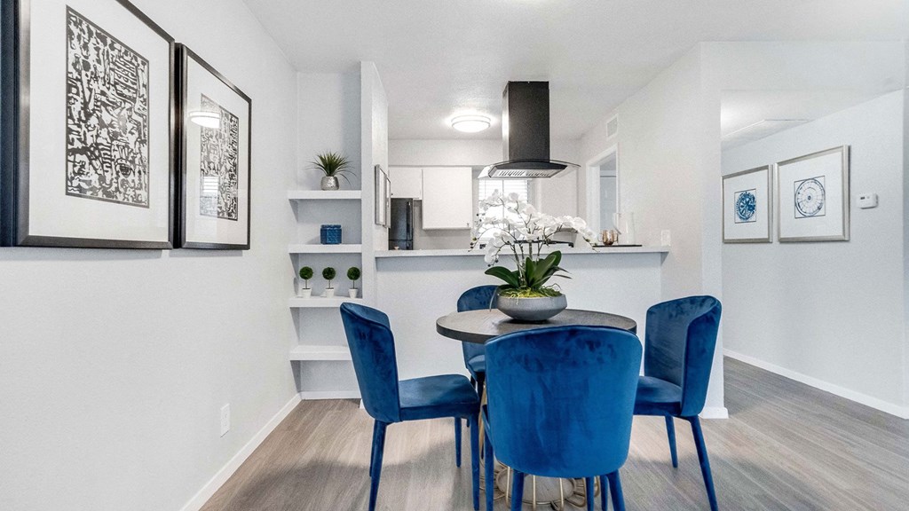 a dining room with blue chairs and a table