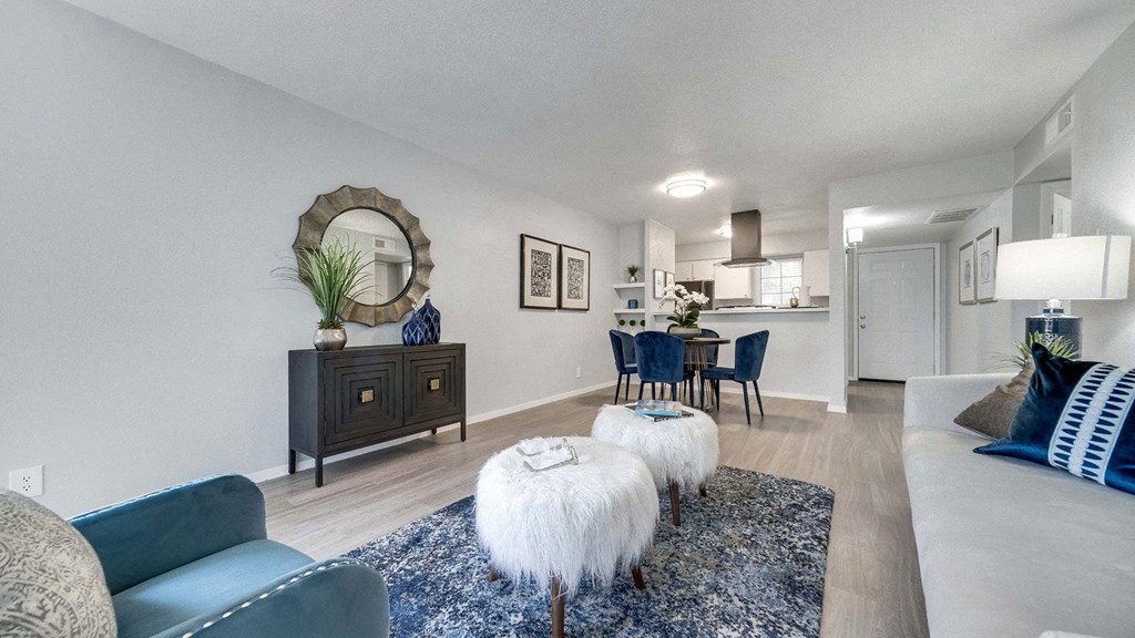 a living room with a couch and a table with chairs