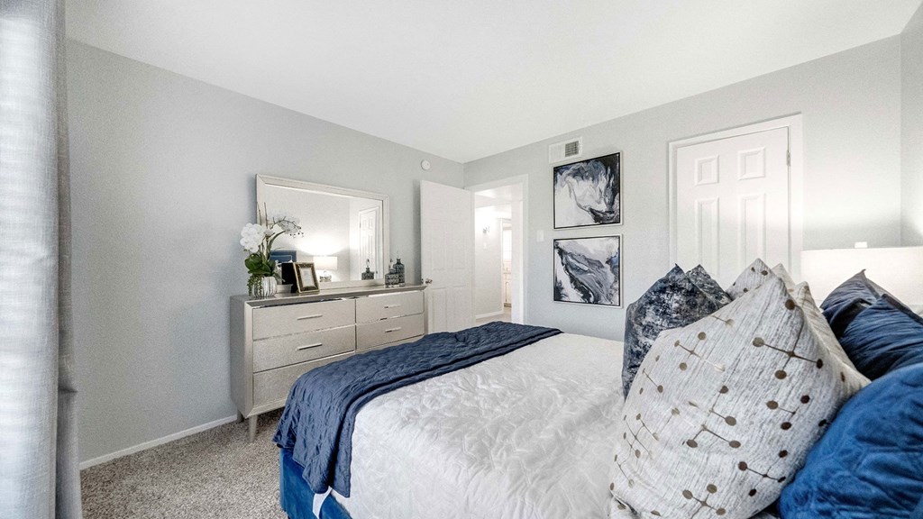 a bedroom with a bed and a dresser