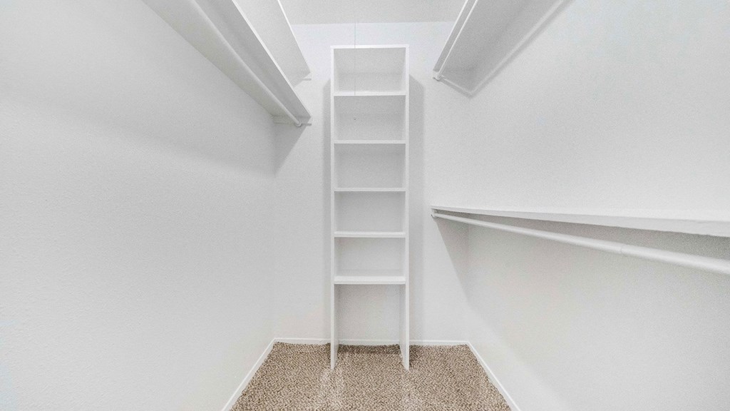 a ladder in a closet in a room with white walls