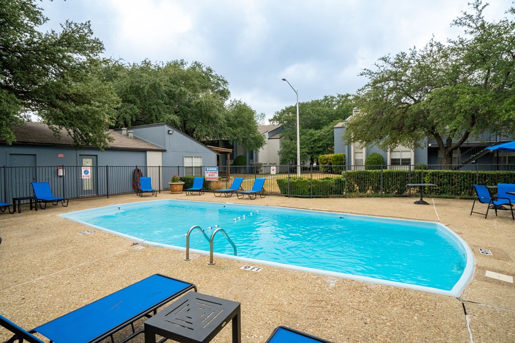 our apartments have a swimming pool with chairs and tables