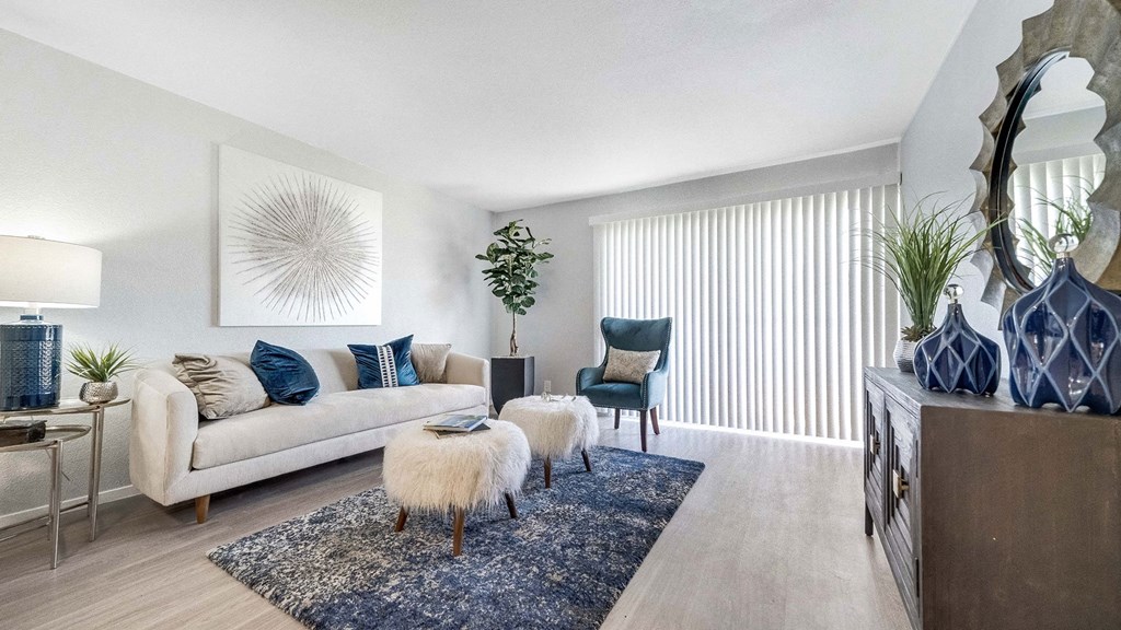 a living room with a couch and a chair and a rug