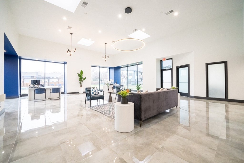 a large living room with a couch and a table with chairs