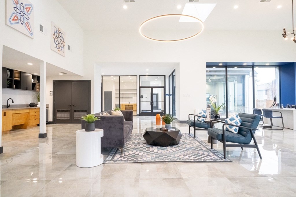a living room with blue and white furniture and a large rug