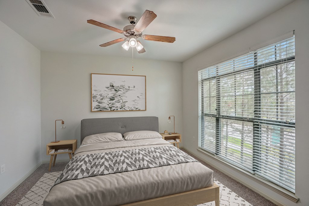 a bedroom with a bed and a ceiling fan