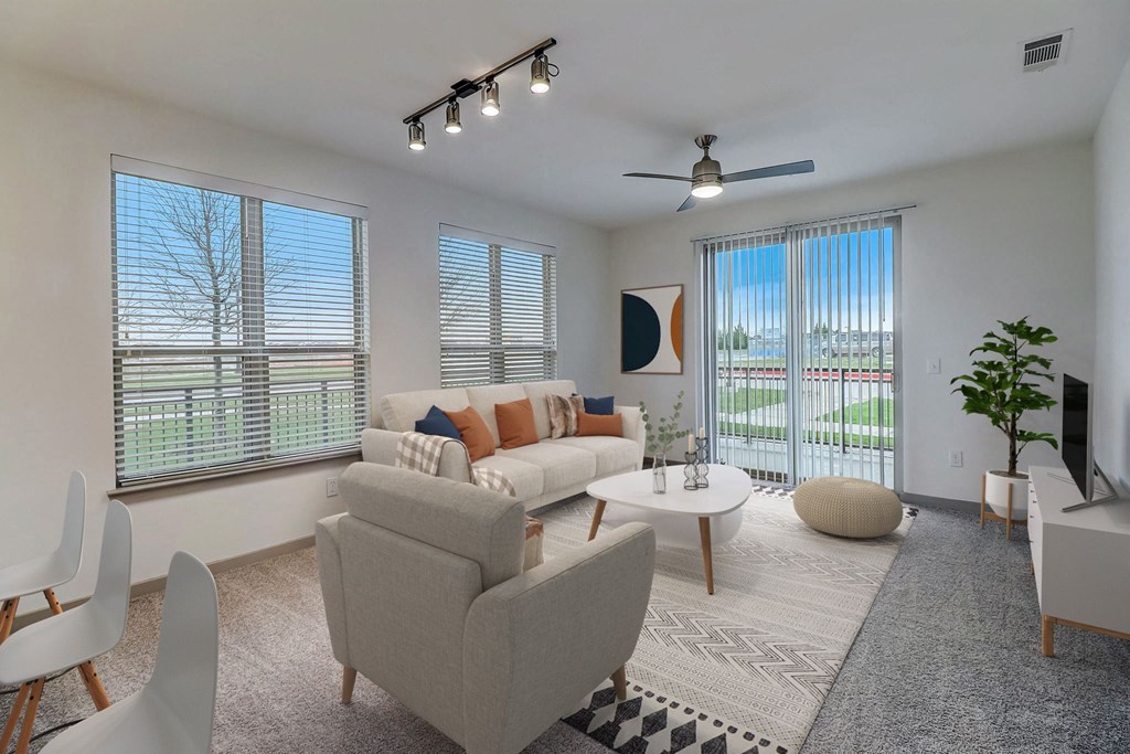 a living room with a couch and chairs and a table
