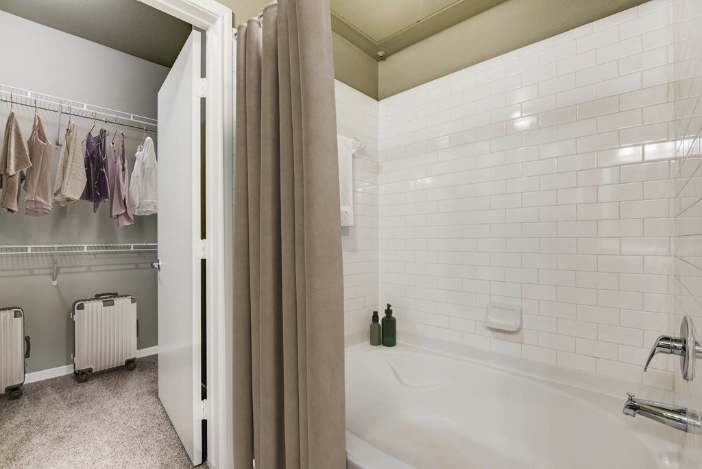 a bathroom with a tub and shower and a shower curtain
