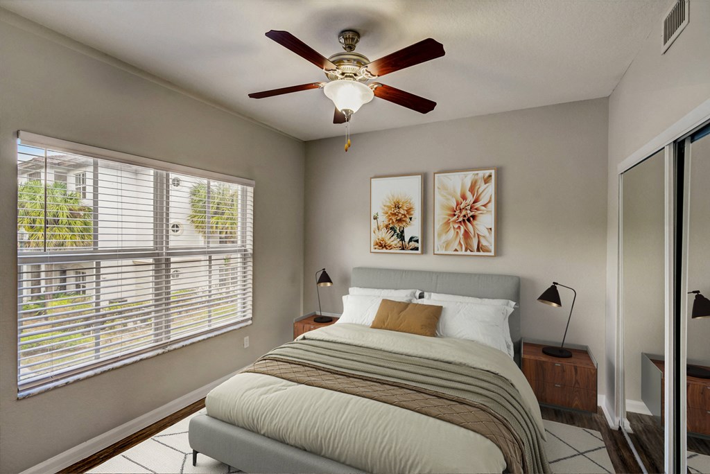 a bedroom with a bed and a ceiling fan