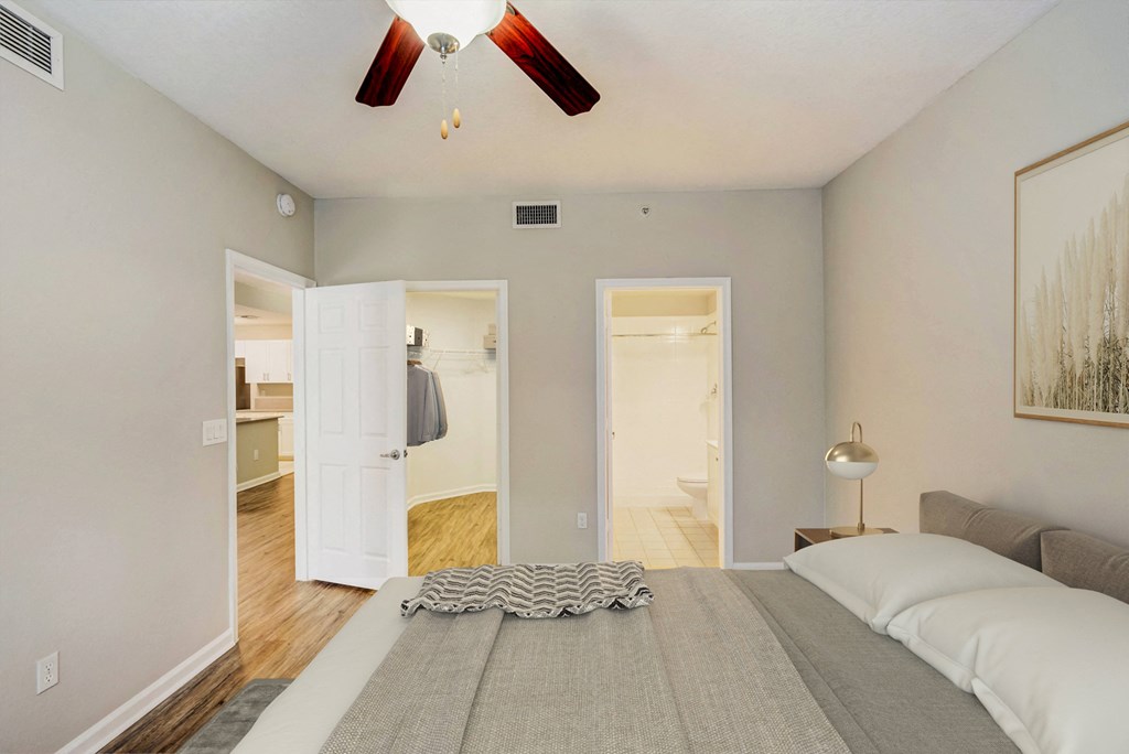 a bedroom with a large bed and a ceiling fan