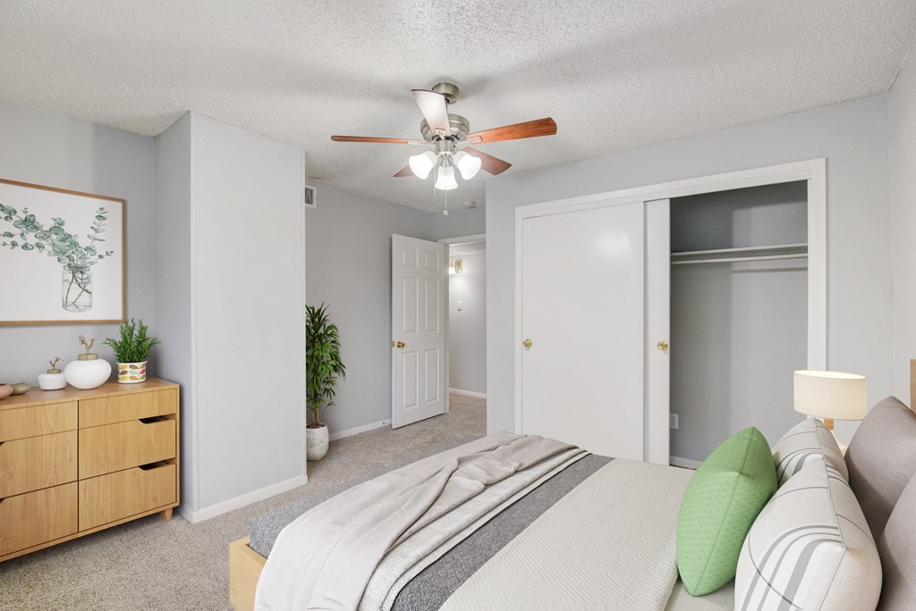 a bedroom with a bed and a ceiling fan