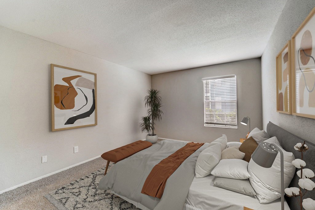 the living room of an apartment with a couch and a bed