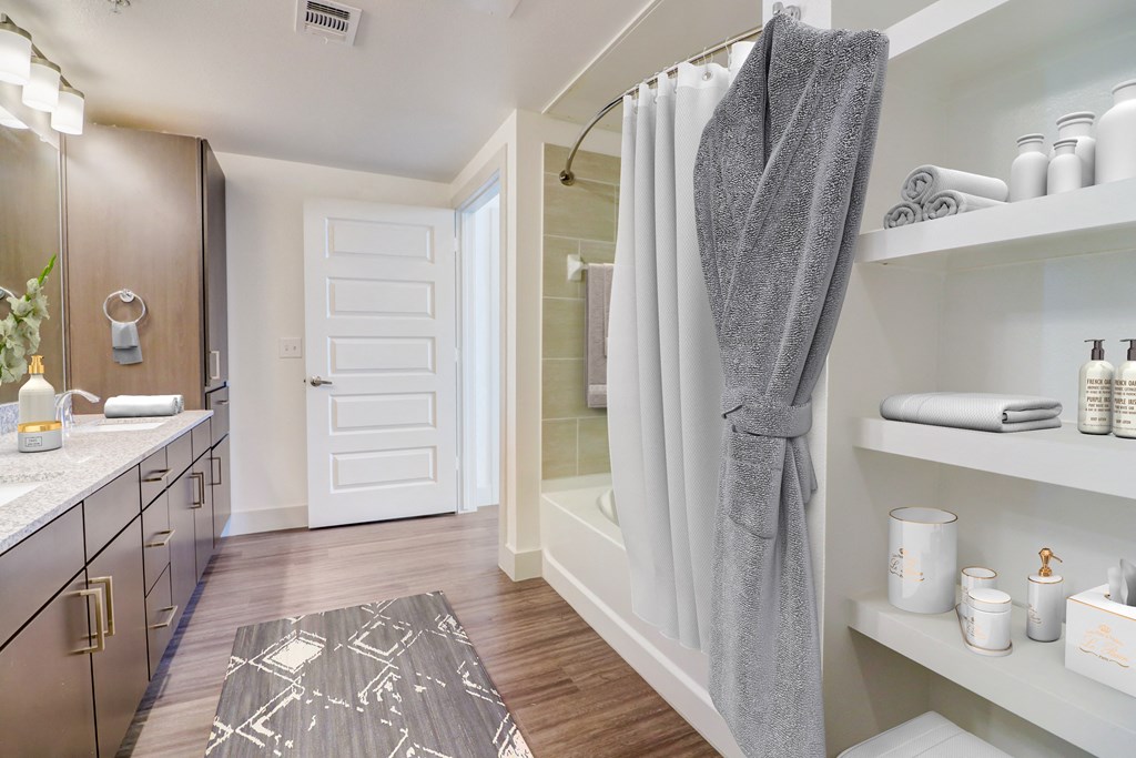 a bathroom with a shower and a sink and a rug