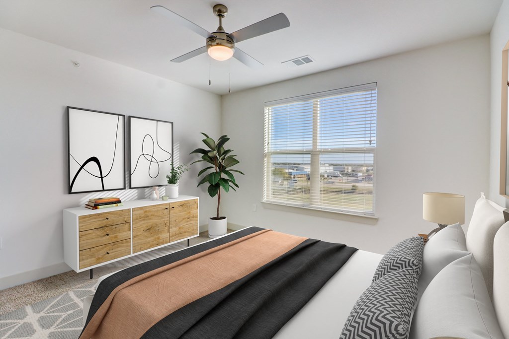 a bedroom with a large bed and a ceiling fan