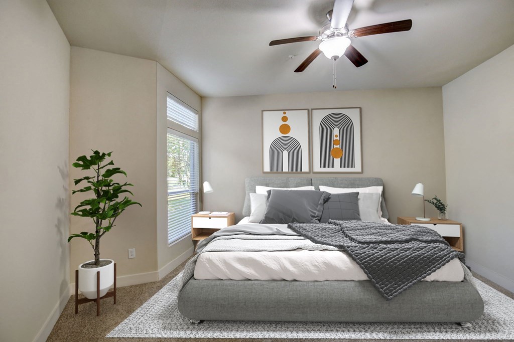 a bedroom with a bed and a ceiling fan